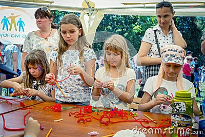 Small girls participating at art and craft outdoor workshop Editorial Stock Photo